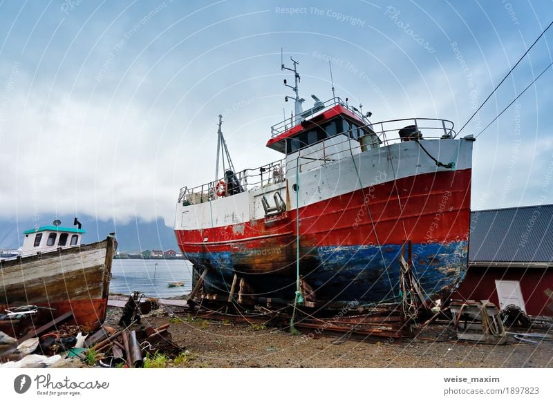 Boat on a coast. Moored boat on a pier. Lofoten Norway islands. Summer Ocean Island Landscape Sky Clouds Coast Bay Fjord Village Small Town Watercraft Old