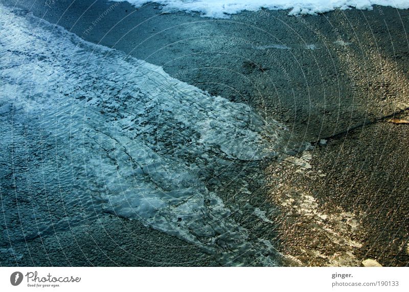 Ice flows into the light Environment Winter Frost Warmth Freeze Blue Brown Yellow Gray Flow Frozen Ice sheet Cold Smoothness Black ice Asphalt Seam Torn