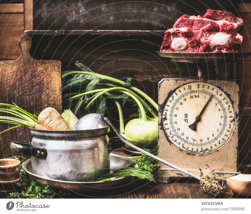 Kitchen table with saucepan, vegetables, old scales and soup meat Food Meat Vegetable Soup Stew Herbs and spices Nutrition Lunch Dinner Organic produce Beverage