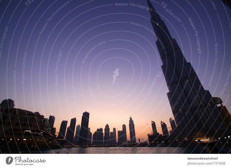 oblique view Dubai Burj Dubai Dubai Tower United Arab Emirates Town Skyline Water Reflection Sunset Twilight High-rise Crane Construction site