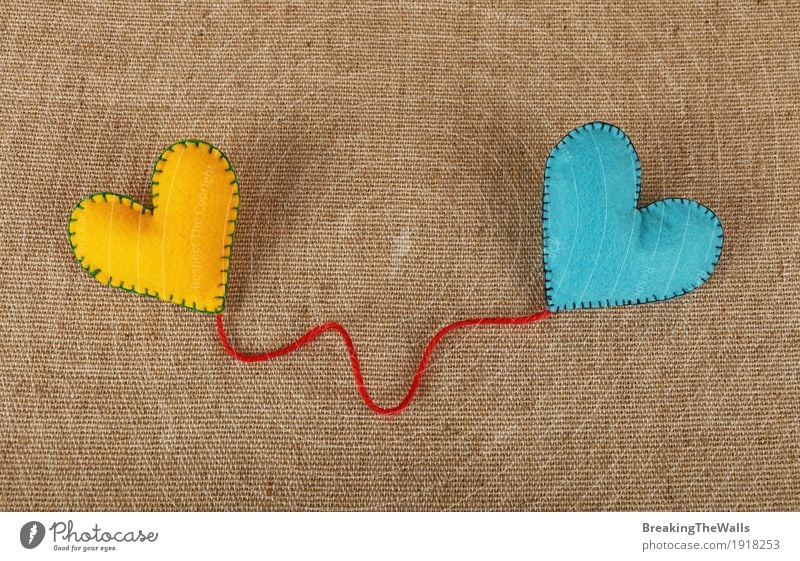 Two stitched felt hearts with red twine on canvas Leisure and hobbies Handicraft Handcrafts Valentine's Day Wedding Art Heart Love Together Natural Blue Yellow