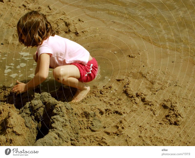 Let's build a sandcastle. Child Lake Sandcastle Human being Water