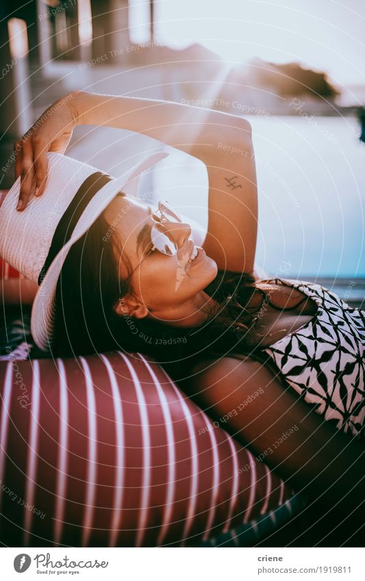 Beautiful young women with sun hat relaxing at the pool smiling Lifestyle Wellness Well-being Relaxation Calm Swimming pool Summer Summer vacation Sunbathing