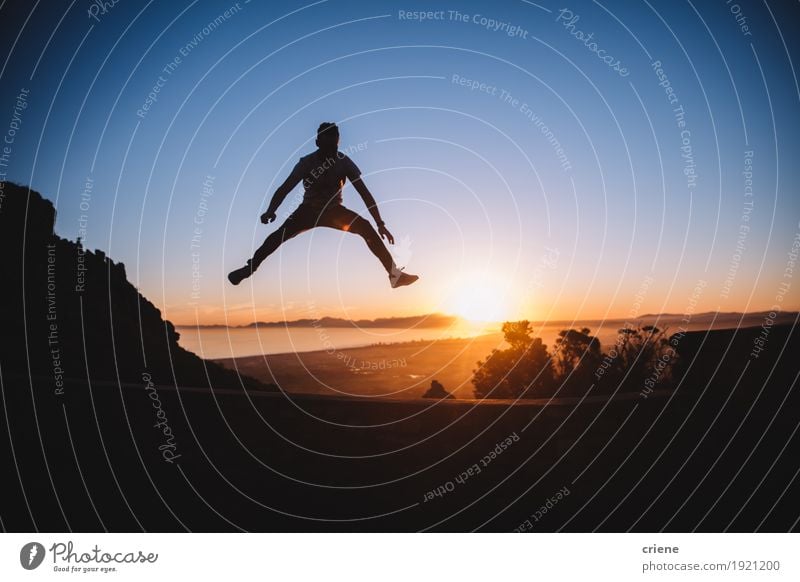 Silhouette of cheerful young man jumping high in sunset Lifestyle Joy Well-being Tourism Trip Adventure Freedom Summer Sun Young man Youth (Young adults) Man