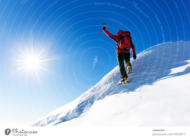 Climber at the top of a snowy peak in the Alps. Vacation & Travel Adventure Expedition Winter Snow Mountain Hiking Sports Climbing Mountaineering Success