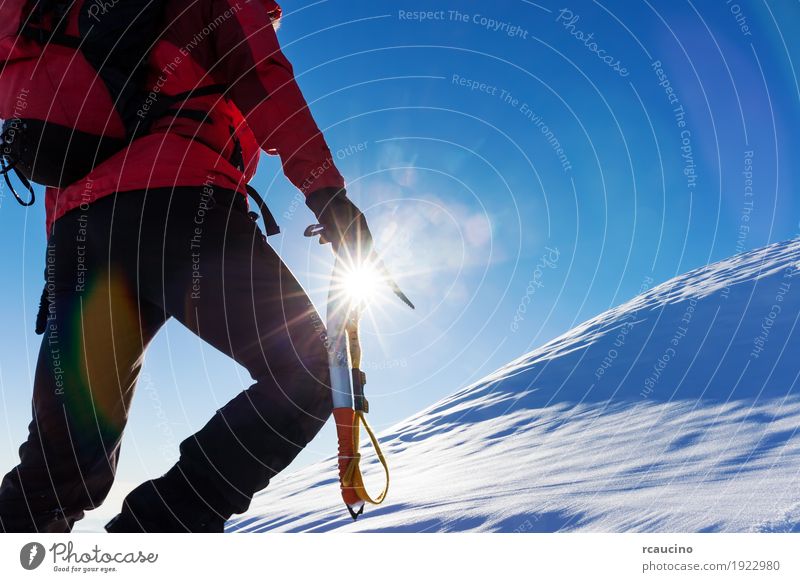 Climber at the top of a snowy peak in the Alps. Vacation & Travel Adventure Expedition Winter Snow Mountain Hiking Sports Climbing Mountaineering Success