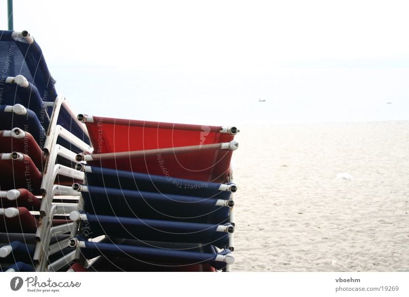 Low season at the beach Beach Deckchair Italy Lake Garda Loneliness Red White Europe Blue