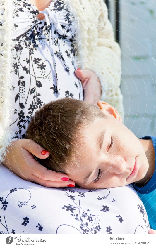 Head boy lying on knees of his pregnant mother Summer Child Schoolchild Human being Girl Boy (child) Woman Adults Man Parents Mother Family & Relations