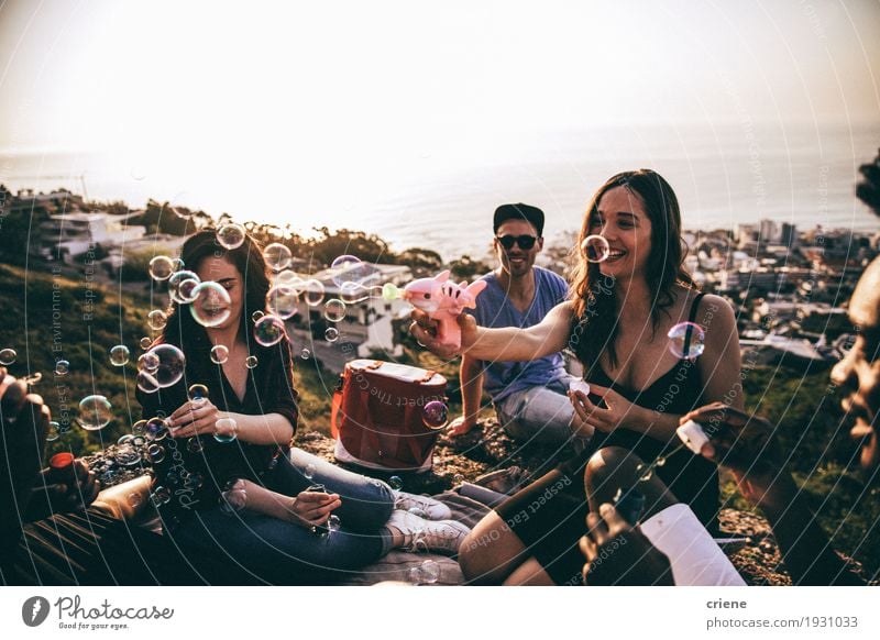 Group of friends having fun blowing bubbles at picninc Lifestyle Joy Summer Party Event Drinking Human being Young woman Youth (Young adults) Young man