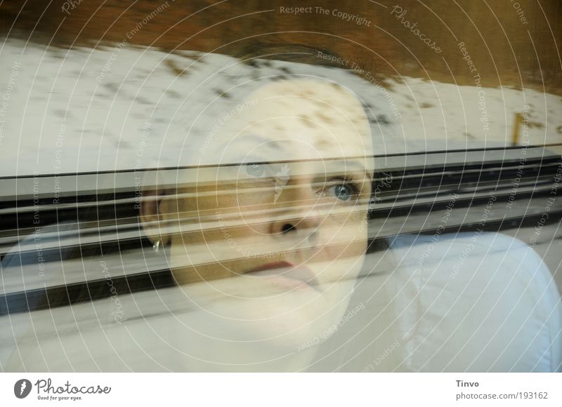 Face of a woman looking out of a train window at the passing train Woman Adults 1 Human being Passenger traffic Train travel Rail transport Passenger train