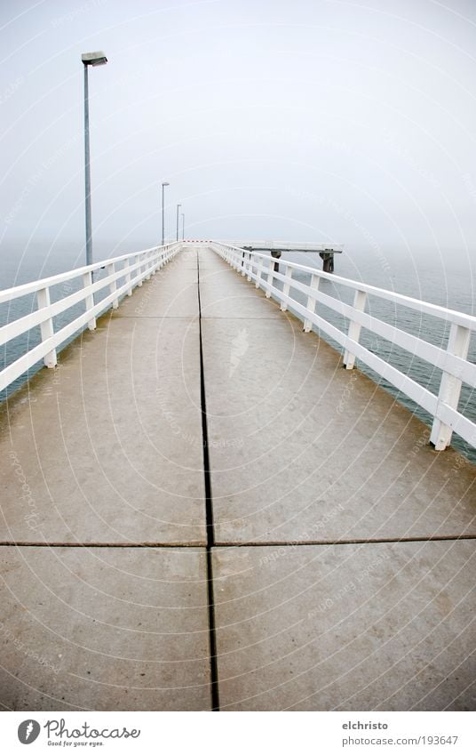 follow the cross Deserted Infinity White Baltic Sea Footbridge Handrail Lamp post Lantern Crucifix Stone slab Far-off places Fog Timmendorf beach Gray Ocean