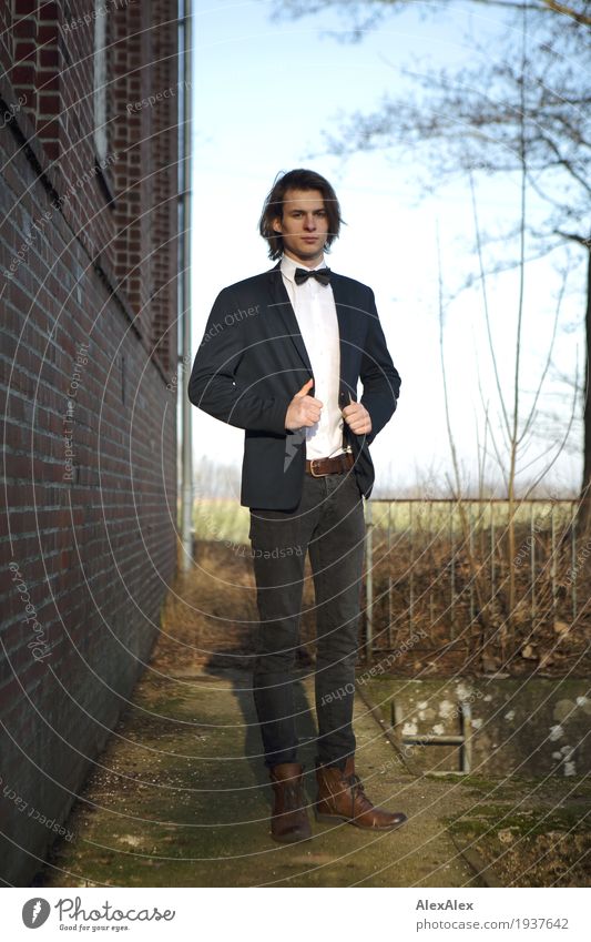 Party outside - young man in suit next to brick building Elegant Style House (Residential Structure) rail Young man Youth (Young adults) 18 - 30 years Adults