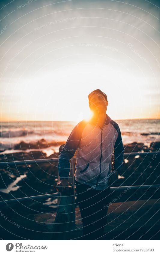 Young hipster adult with longboard in sunset on promenade Lifestyle Style Joy Leisure and hobbies Ocean Waves Sports Human being Masculine Young man