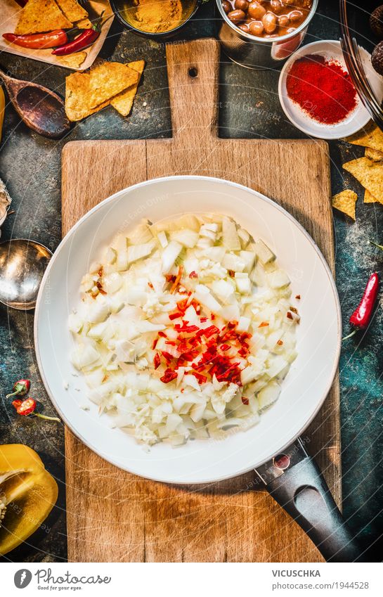 Spicy Cooking . Frying pan with onion, garlic and chili Food Herbs and spices Nutrition Organic produce Vegetarian diet Diet Crockery Bowl Pan Style Design