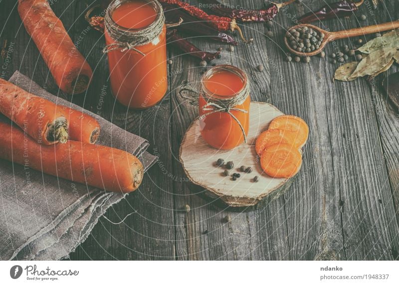 Fresh carrot juice with pulp among the vegetables and spices Vegetable Herbs and spices Nutrition Vegetarian diet Diet Beverage Juice Bottle Table Kitchen