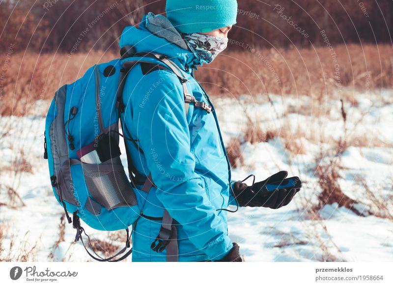 Boy using the mobile phone during the winter trip Lifestyle Joy Vacation & Travel Trip Freedom Winter Snow Winter vacation Sports Hiking Cellphone Technology