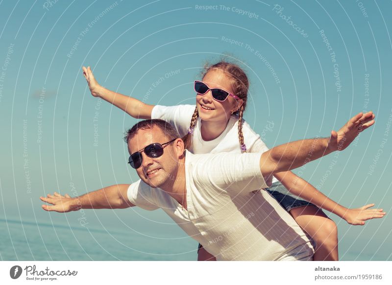 Father and daughter playing on the beach at the day time. Lifestyle Joy Relaxation Leisure and hobbies Playing Vacation & Travel Trip Freedom Summer Sun Beach