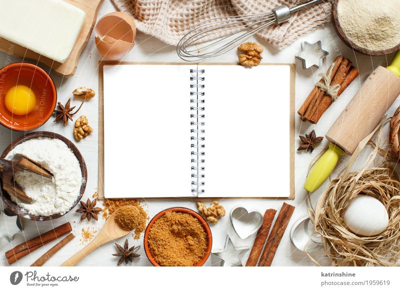 Blank cooking book, ingredients and utensils for baking Dough Baked goods Dessert Herbs and spices Bowl Table Kitchen Paper Wood Fresh Brown White background