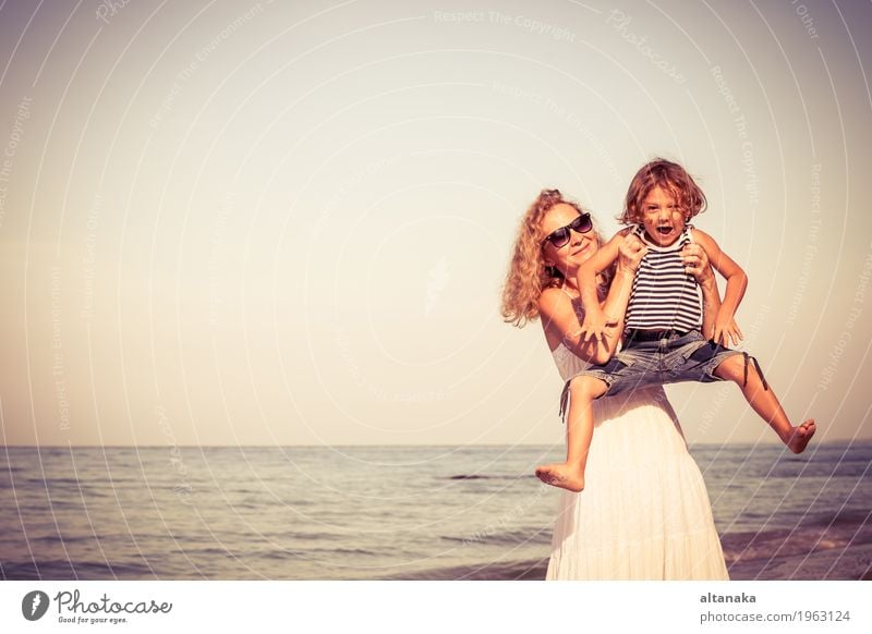 Mother and son playing on the beach at the day time. Lifestyle Joy Relaxation Leisure and hobbies Playing Vacation & Travel Trip Freedom Summer Sun Beach Ocean