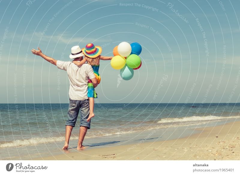 Father and daughter with balloons playing on the beach Lifestyle Joy Relaxation Leisure and hobbies Playing Vacation & Travel Trip Freedom Summer Sun Beach