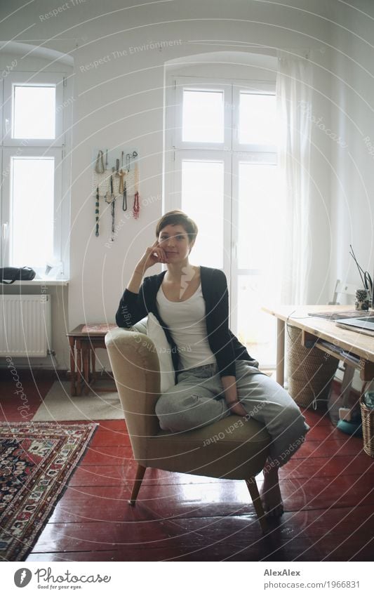 Young, tall, slim student sits on a chair at her desk and takes a short break Lifestyle Style pretty Flat (apartment) Desk Armchair Table Young woman