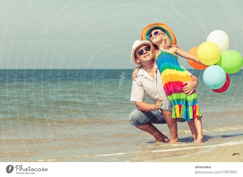 Father and daughter with balloons playing on the beach Lifestyle Joy Relaxation Leisure and hobbies Playing Vacation & Travel Trip Freedom Summer Sun Beach