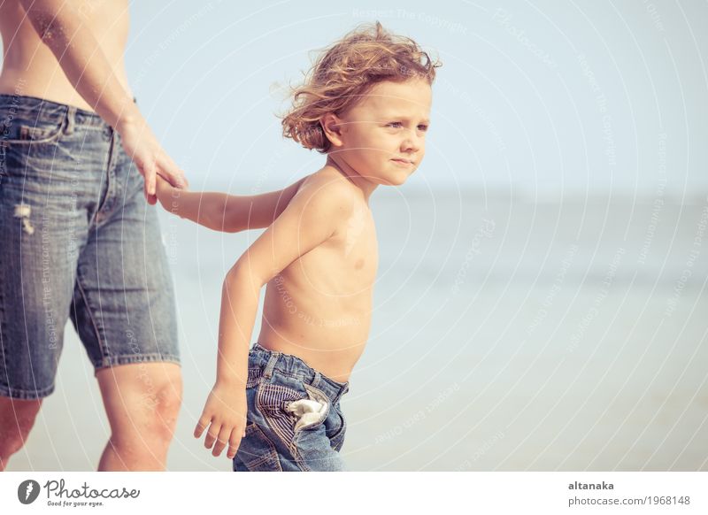 Mother and son playing on the beach at the day time. Concept of friendly family. Lifestyle Joy Relaxation Leisure and hobbies Playing Vacation & Travel Trip