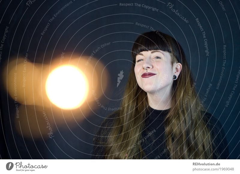 Carina - happy woman in front of black wall with light effect Light Light (Natural Phenomenon) Young woman 18 - 30 years Face Exceptional Cool (slang) Brunette