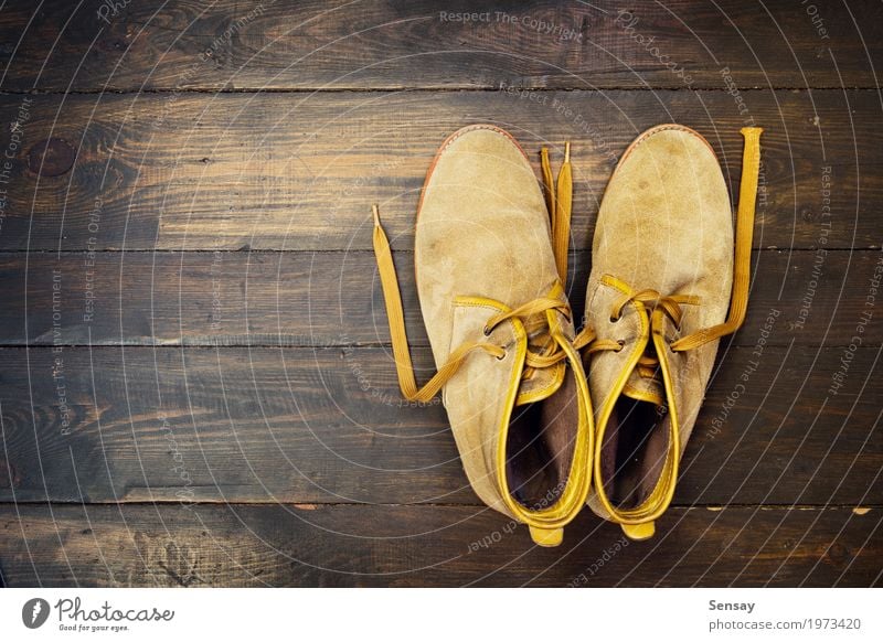 Desert shoes on the wooden backdrop Work and employment Fashion Leather Footwear Boots Wood Old Brown Tradition background vintage boot Grunge Consistency