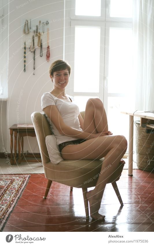 Young, athletic student with long, bare legs sits at her desk and laughs into the camera Lifestyle Style Joy pretty Well-being Flat (apartment) Armchair