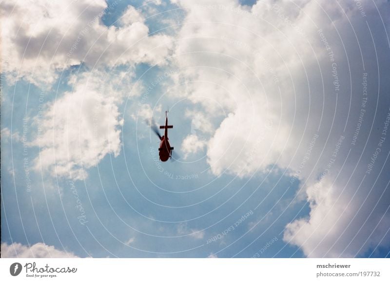 Helicopter in the cloudy sky Clouds Sunlight Aviation Rescue helicopter Speed Blue Colour photo Exterior shot Day Light Contrast Silhouette Wide angle