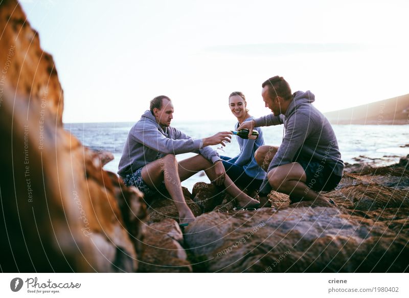 Young adult friends having picnic with wine by ocean Drinking Alcoholic drinks Wine Bottle Lifestyle Vacation & Travel Adventure Beach Ocean