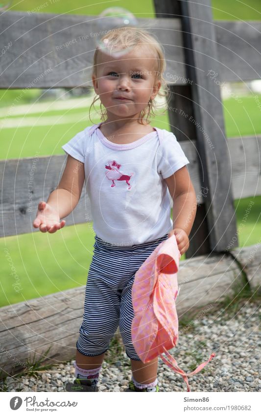 Seifenblase Human being Child Girl Infancy 1 1 - 3 years Toddler Emotions Moody Joy Smiling Happy Fence Bubble Blonde Colour photo Exterior shot Close-up