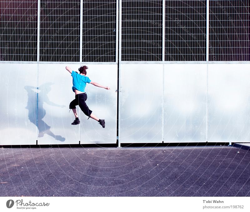 Now I'm jumping Joy Leisure and hobbies Human being Young man Youth (Young adults) 1 Gate Street Jump Free Thin Athletic Blue Tunnel entrance Grating Tall