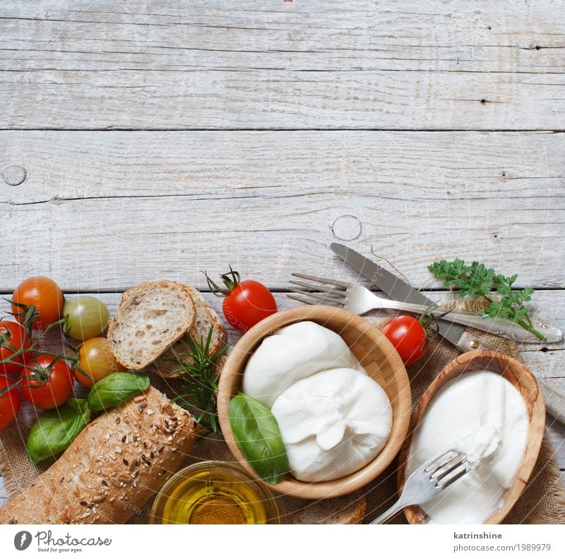 Italian cheese burrata with bread, vegetables and herbs Cheese Vegetable Bread Herbs and spices Cooking oil Nutrition Vegetarian diet Italian Food Bowl Knives