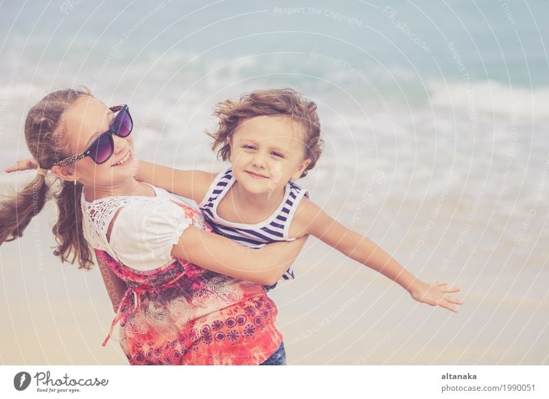 Sister and brother playing on the beach at the day time. Concept Brother And Sister Together Forever Lifestyle Joy Happy Beautiful Relaxation