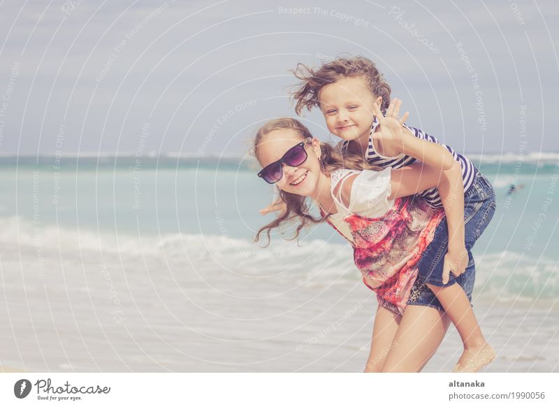 Sister and brother playing on the beach at the day time. Lifestyle Joy Happy Beautiful Relaxation Leisure and hobbies Playing Vacation & Travel Freedom Summer