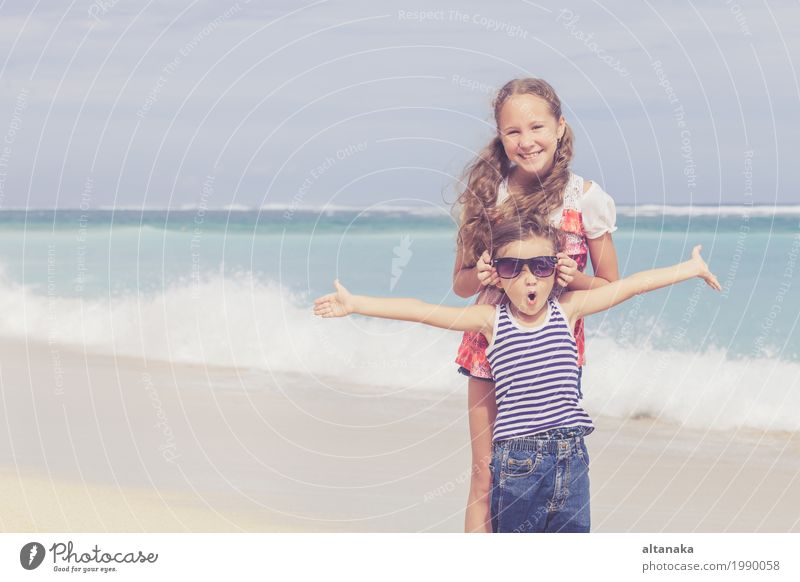 Sister and brother playing on the beach at the day time. Lifestyle Joy Happy Beautiful Relaxation Leisure and hobbies Playing Vacation & Travel Freedom Summer