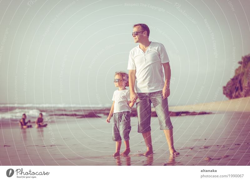 Father and son playing on the beach at the day time. Concept of friendly family. Lifestyle Joy Relaxation Leisure and hobbies Playing Vacation & Travel Trip