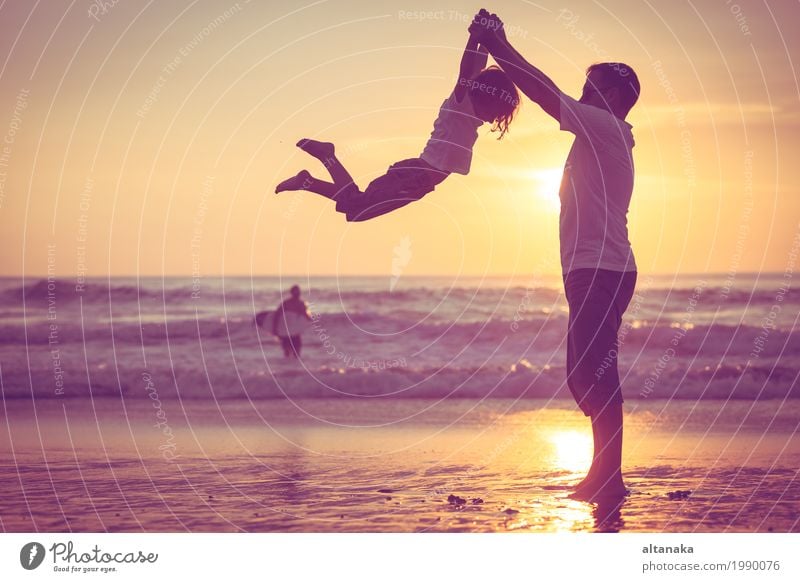 Father and son playing on the beach at the sunset time. Lifestyle Joy Leisure and hobbies Playing Vacation & Travel Trip Freedom Summer Sun Beach Ocean Child