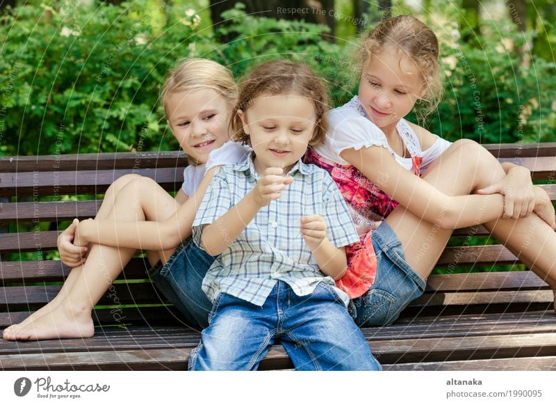 Three happy children playing in the park at the day time. Concept Brother And Sister Together Forever Lifestyle Joy Happy Beautiful Face Leisure and hobbies