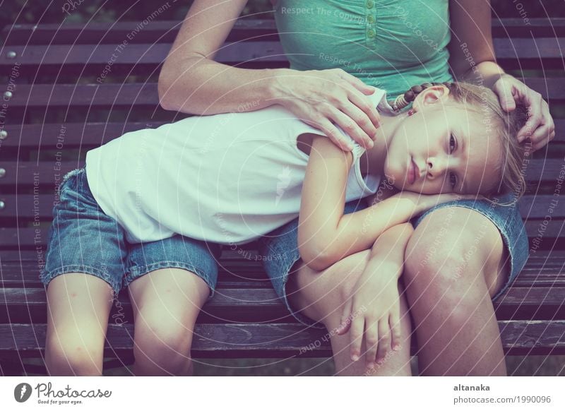 Sad mother and daughter sitting on bench in the park at the day time. Lifestyle Face Healthy Summer Child Human being Girl Woman Adults Parents Mother