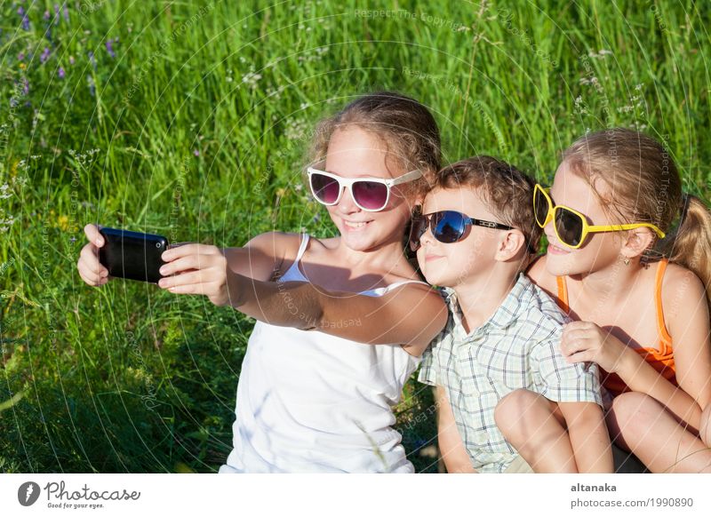 Three happy children playing in the park at the day time. Lifestyle Joy Happy Beautiful Face Leisure and hobbies Playing Vacation & Travel Freedom Summer Child