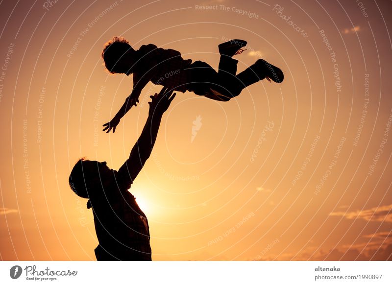 Father and son playing on the beach at the sunset time. Lifestyle Joy Happy Leisure and hobbies Vacation & Travel Adventure Freedom Camping Summer Sun Beach