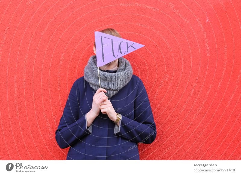 Woman holding pennant that says FUCK Feminine Young woman Youth (Young adults) Adults 1 Human being 30 - 45 years Wall (barrier) Wall (building) Coat Cloth