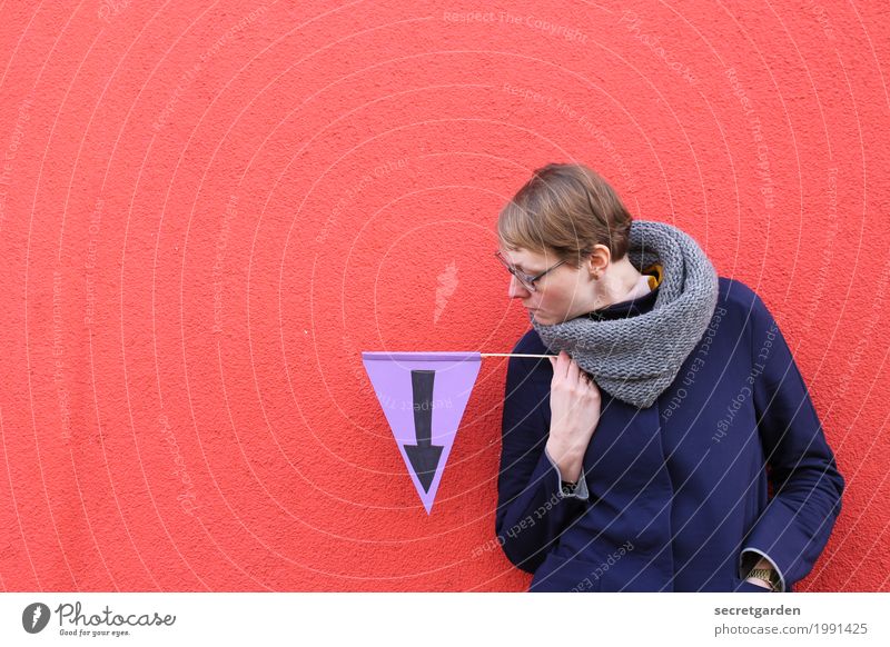 Woman holds pennant in hand which has down arrow Elegant Feminine Adults 1 Human being 30 - 45 years Wall (barrier) Wall (building) Eyeglasses Scarf Blonde