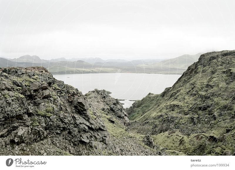 cold lake on Iceland Environment Landscape Cold Lake Stone Rock Moss Gravel Far-off places Vantage point Hill Clouds Pallid Gray Empty Nature Calm Loneliness