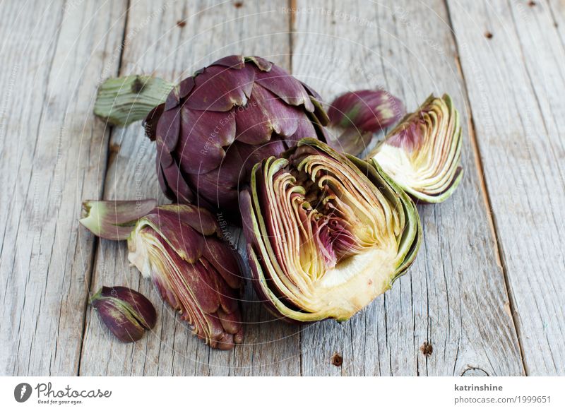 Roman Artichokes on a wooden board Vegetable Nutrition Vegetarian diet Fresh Gray Green agriculture Purple cooking Cut Edible food Half Ingredients