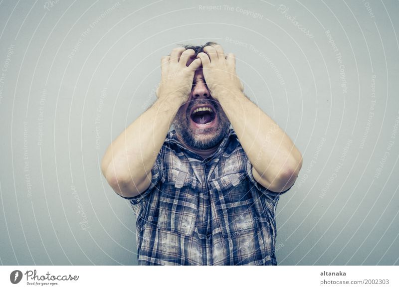 portrait one sad man standing near a wall and covers his face at the day Face Human being Boy (child) Man Adults Family & Relations Hand Sadness Anger Emotions