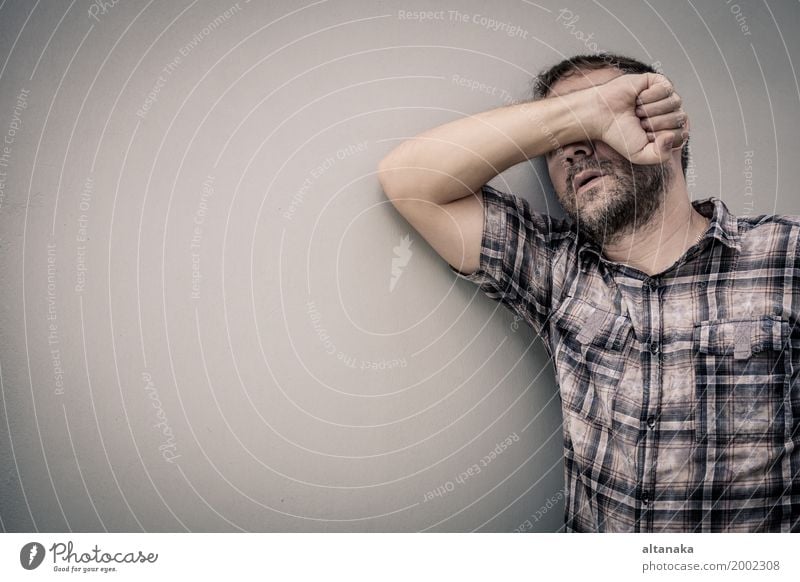 portrait one sad man standing near a wall and covers his face at the day Face Human being Boy (child) Man Adults Family & Relations Hand Sadness Anger Emotions